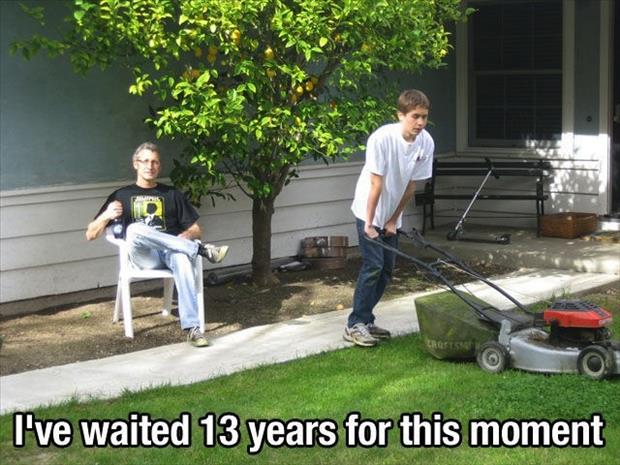 dad watches son mow the lawn