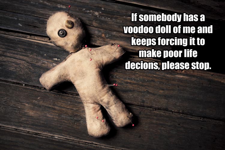 creepy voodoo doll on wooden floor.